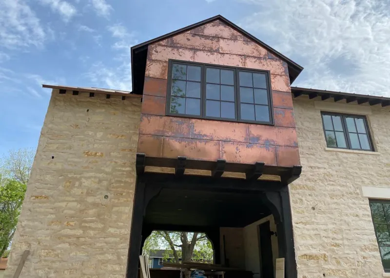 Copper metal panel facade on a stone building for Metal Roof Coating in Sedalia